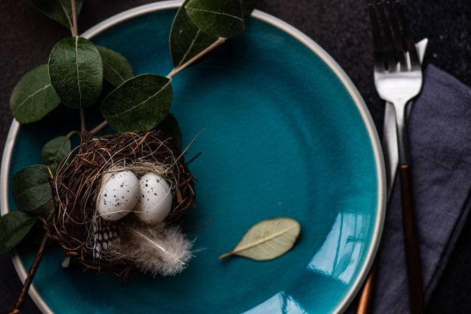 Easter table setting with nest on blue plate