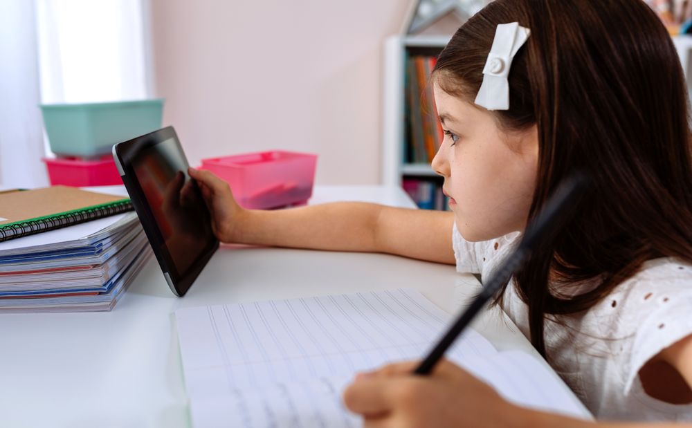 Girl doing homework with the tablet