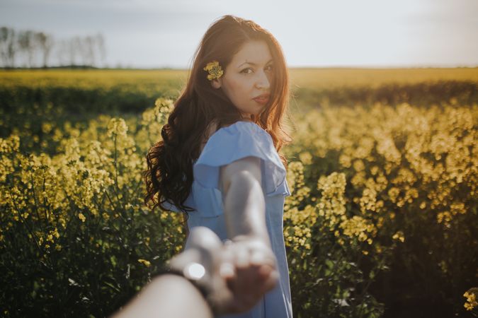 woman offer to follow her in flower field