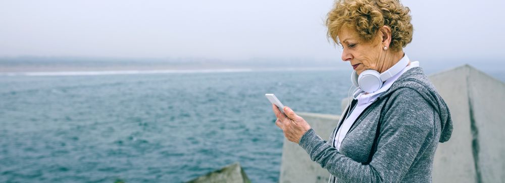 Mature sportswoman looking at her smartphone