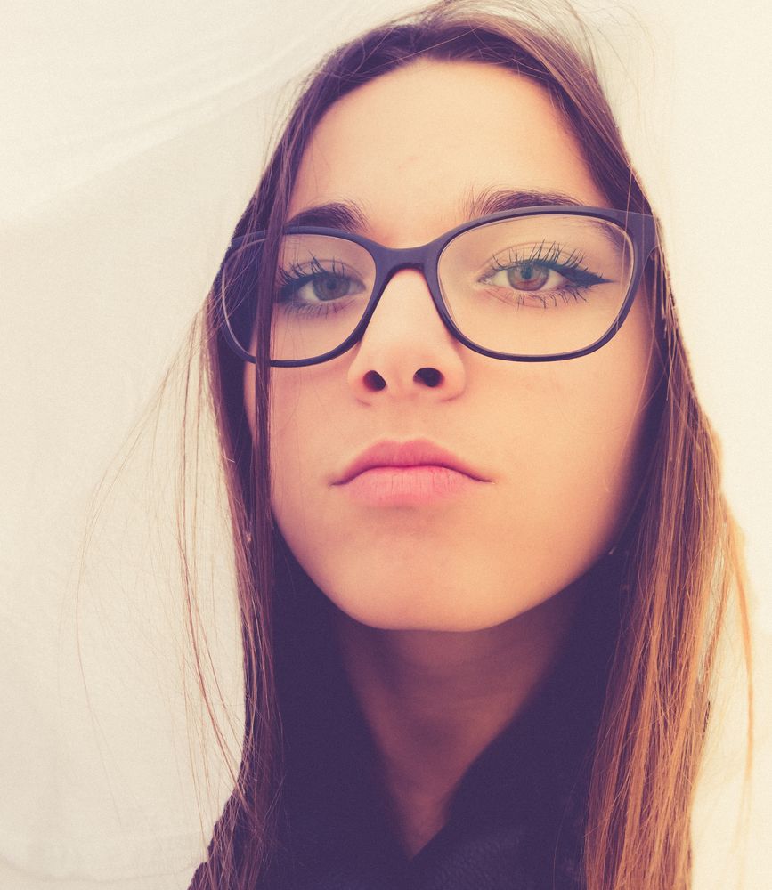 Woman in eyeglasses between textile