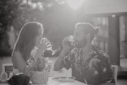 Loving couple clinking glasses on cafe terrace