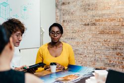 Black woman with colleagues in design firm