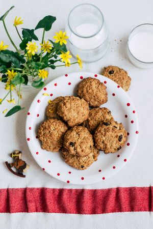 Cookies and milk near flowers