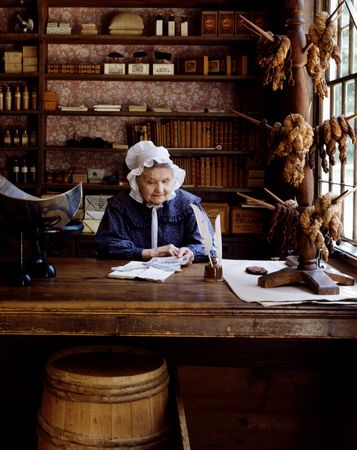 Costumed clerk at the restored general store at Old Sturbridge Village, Sturbridge, Massachusetts