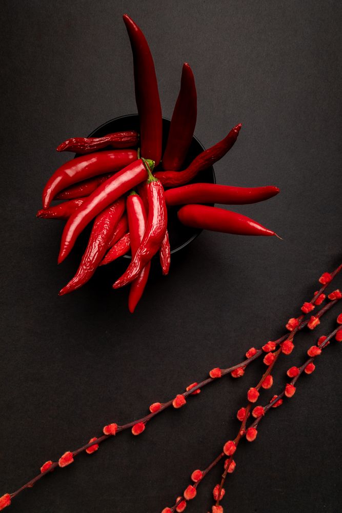 Cloth and branches near peppers and strawberries