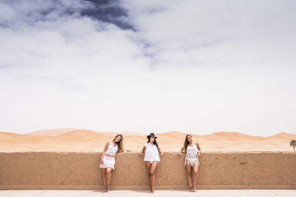 Women in white on desert landscape