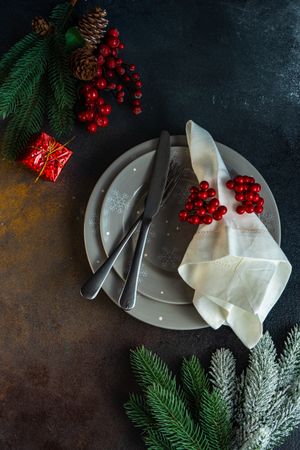 Top view of holiday table setting with grey plates