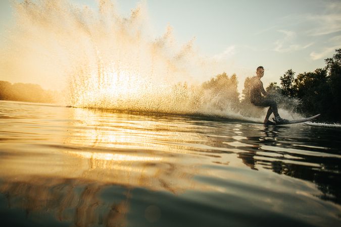 Man water skiing at sunset