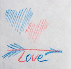 Valentine Day holiday card concept with hearts and the word "love" on paper