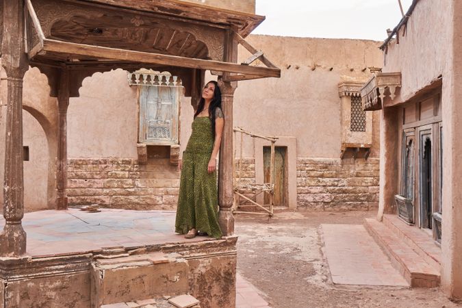 Woman dancing on street stage between ancient buildings