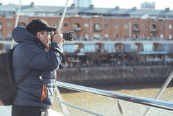 Traveler photographer taking photos at Puerto Madero's canal