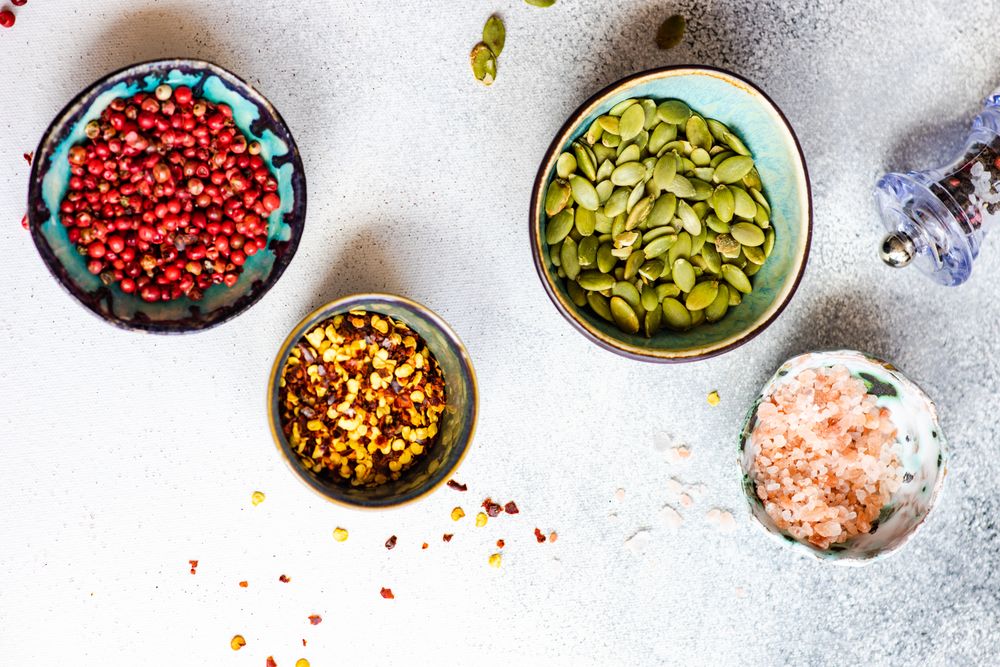 Top view of seeds & seasoning in small bowls