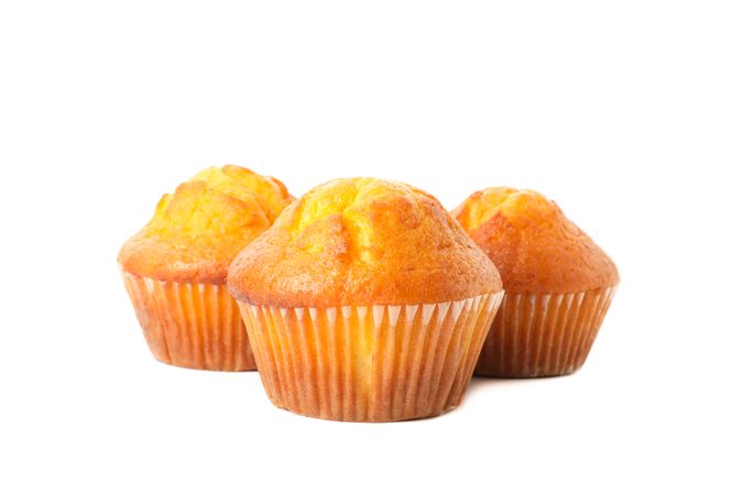 Delicious tasty muffins isolated on light background