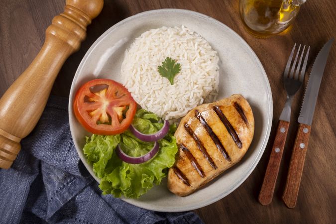 Grilled chicken with salad and rice.