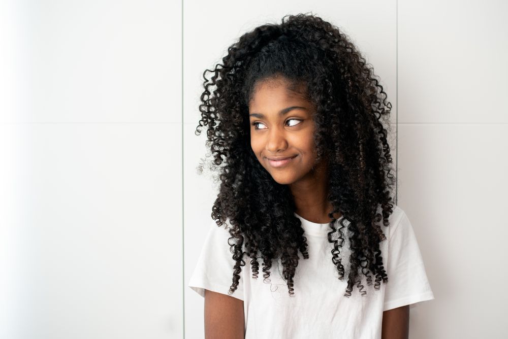 Portrait of a beautiful young Black teenage girl looking into camera