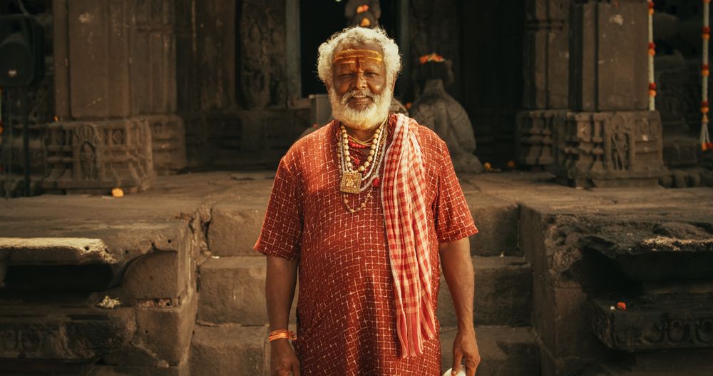 Authentic Footage of Hindu Priest Tying a Mauli Thread Around a Female Temple Follower's Wrist.