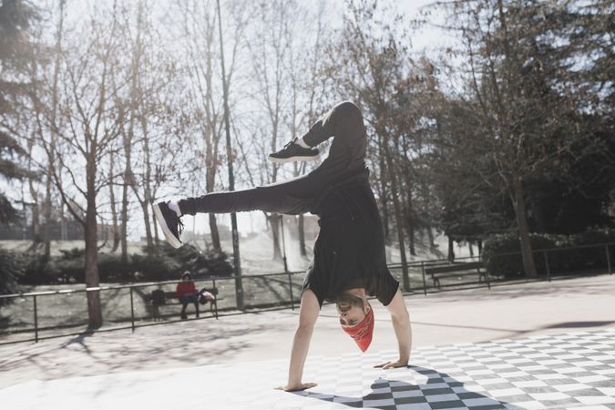 Man dancing break dance in park