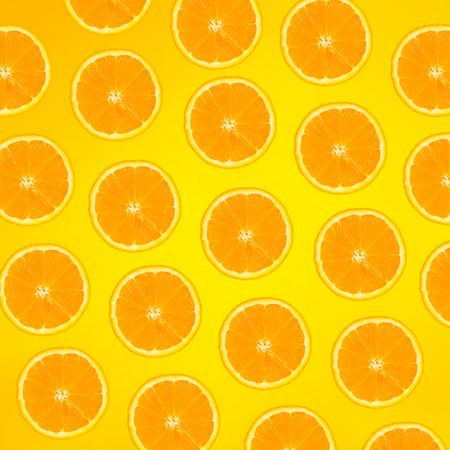 Pattern of orange slices on yellow background