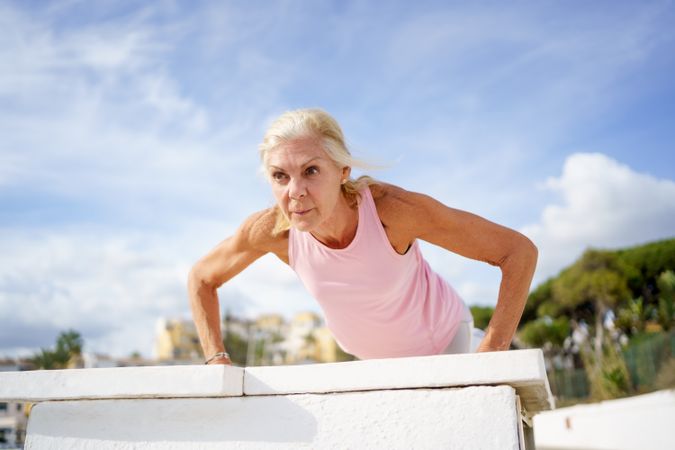 Mature female doing push ups or press ups exercise