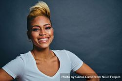 Smiling Black woman with short blonde hair with hands on her hips bGnLB4