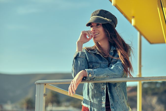 female standing on balcony on nature