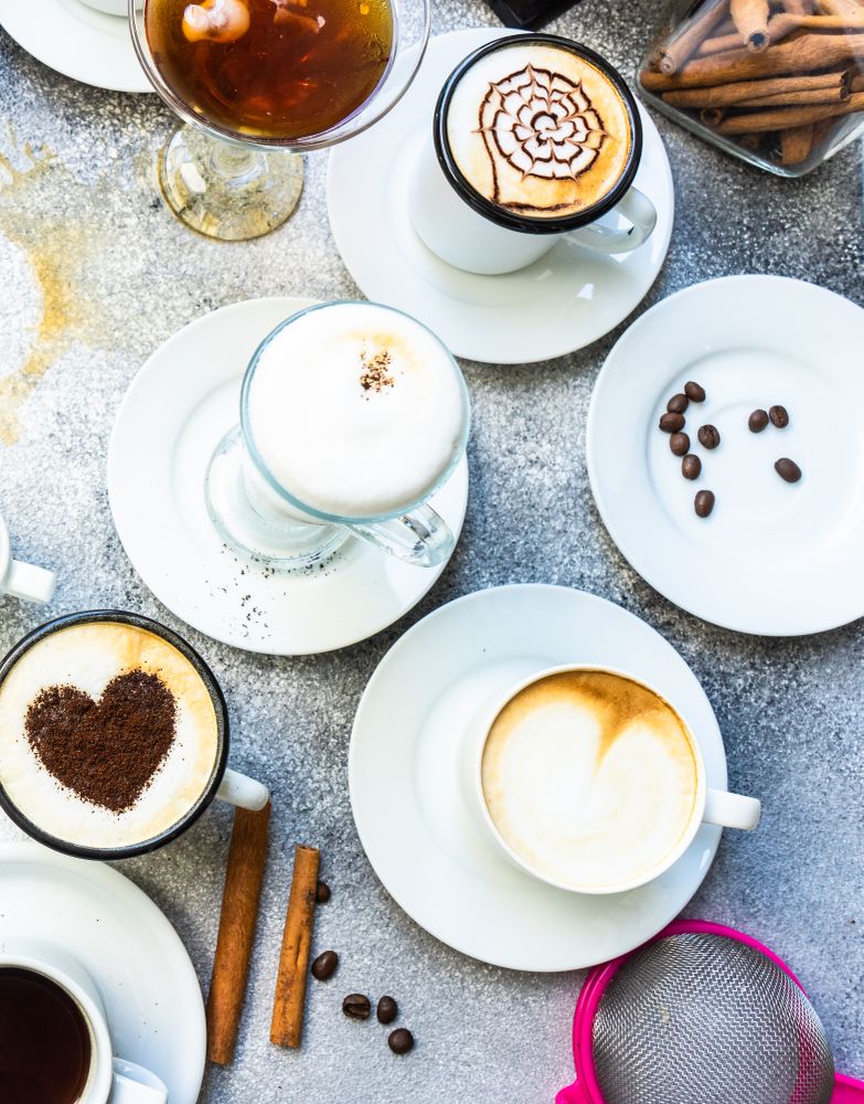 Top view of a variety coffees with foam art