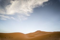 Cloud over sand dune in desert