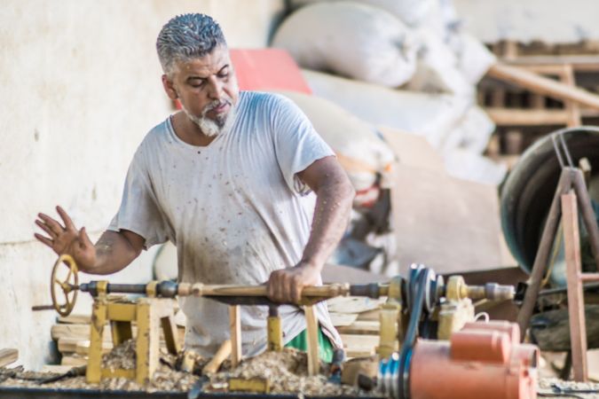 Man using woodworking machine at workplace