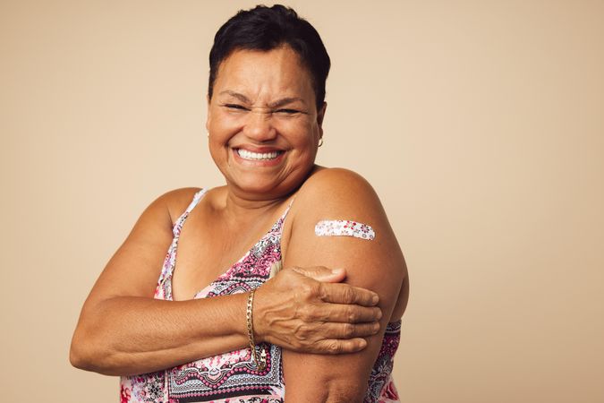 Portrait of a smiling older woman receiving a vaccine