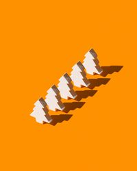 Five light trees on orange background