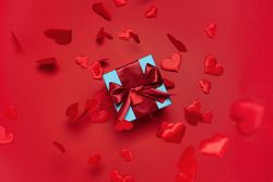 Blue box with red bow on red background