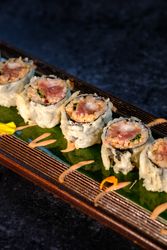 Delicious fried sushi with cream on tray