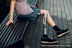 Man sitting on bench with prosthesis leg 0PWyOb
