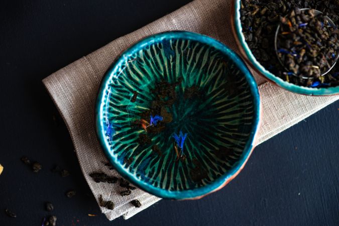 Tea time concept of blue bowls with petals