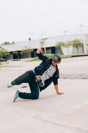 Skillful break dancer performing handstand while moving