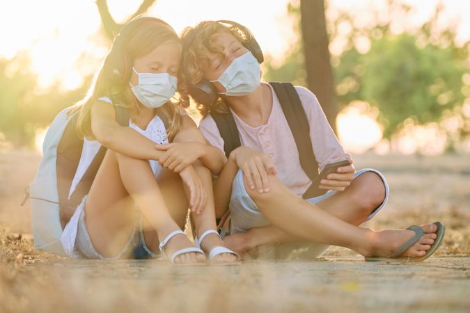 Children in masks listening to music together