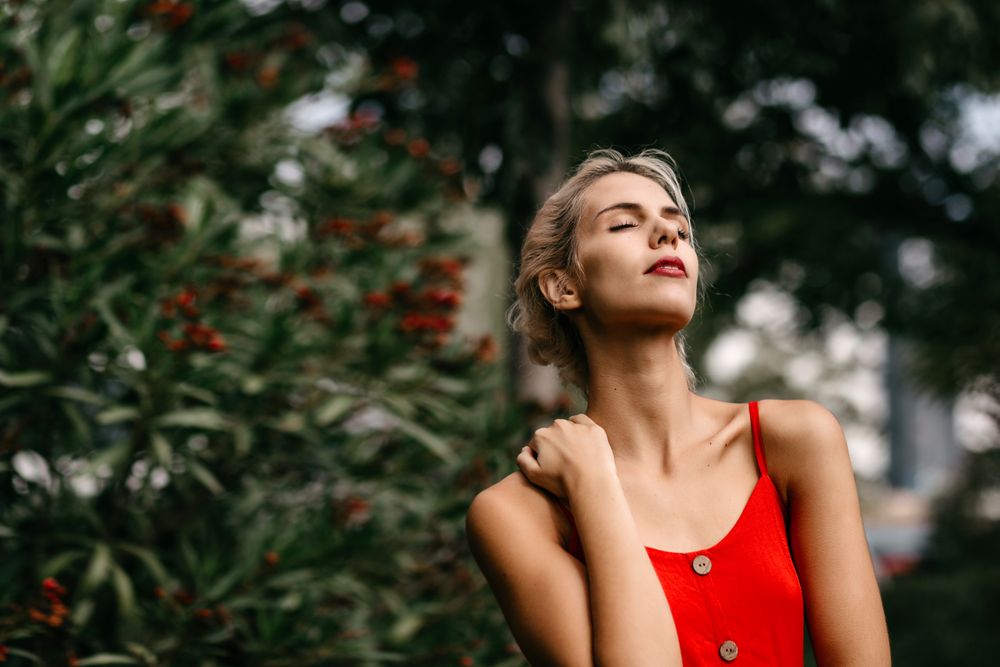Dreamy young woman in summer garden