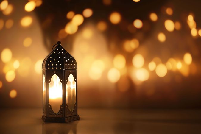Dark silhouette of Moroccan lantern glowing at night