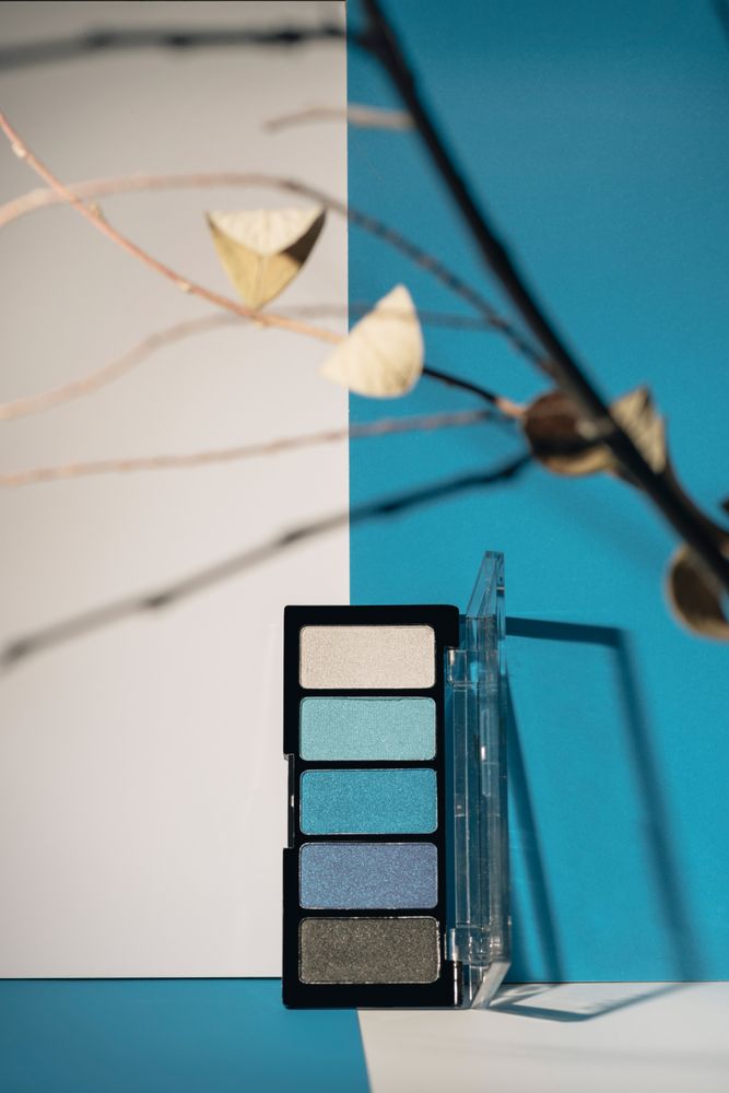 soft blue eyeshadow palette on geometric background.