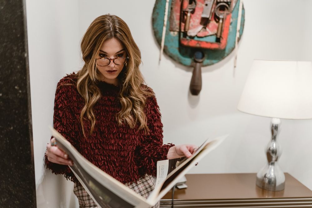 Stylish woman reading magazine