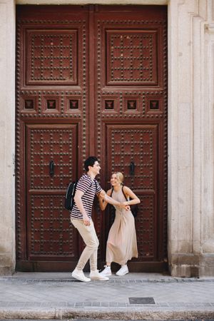 Happy couple having fun while walking in town