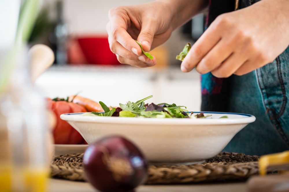 Woman preparing vegetable salad
