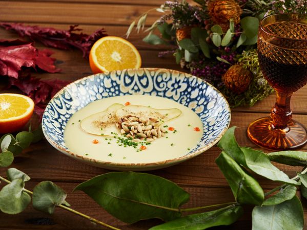 Citruses and wine cream soup amidst floral twigs