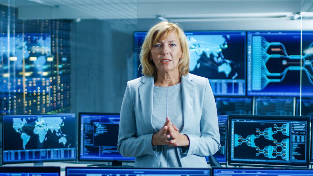 In the System Control Room Female Chief Engineer Describes Her Project Talking into the Camera.