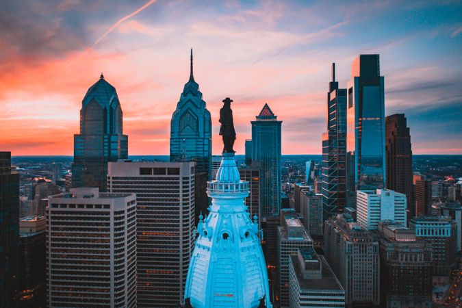 William Penn statue in Pennsylvania city skyline at sunset in Philadelphia, US
