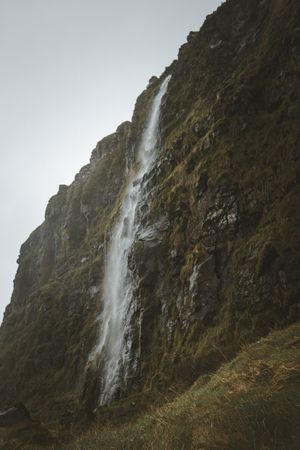Huge mossy cliff with cascade