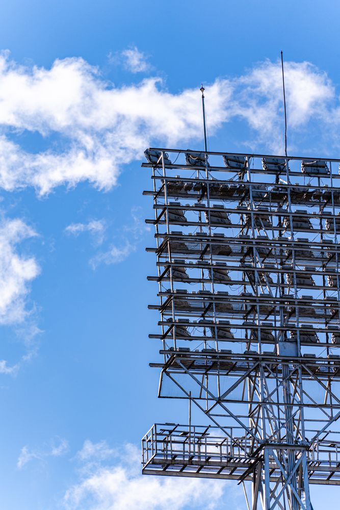 Stadium lights on the blue sky background