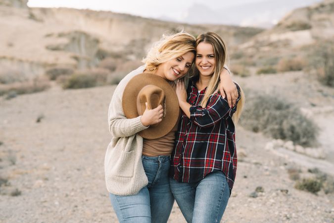 Content blond women cuddling on nature