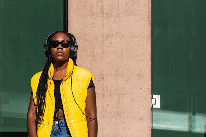 Trendy female listening to music on street